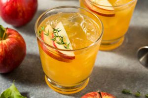 fresh sweet apple cider cocktail with bourbon and thyme